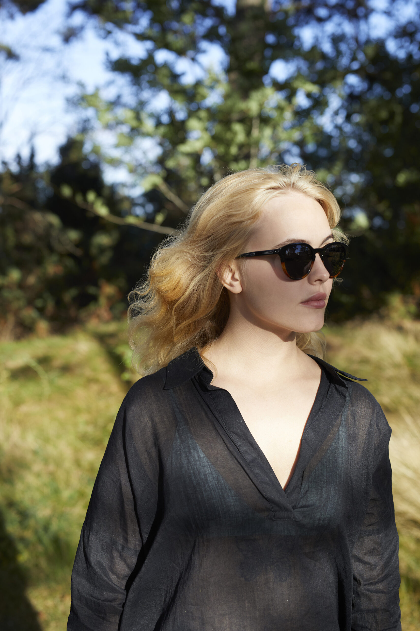 woman wearing sunglasses in forest